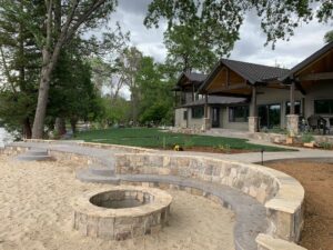 Landscaping and hardscaping with a fire pit, lakeside environment.